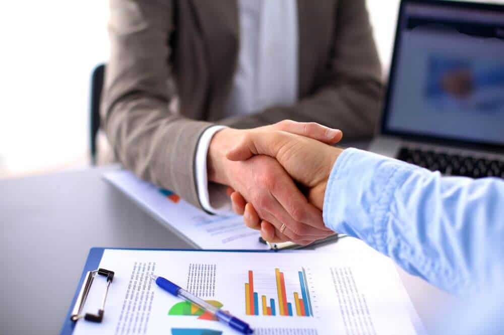 pessoas apertando as mãos. Imagem ilustrativa do texto sobre franchising e licenciamento